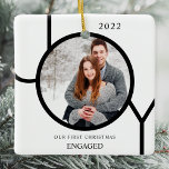Ornamento De Cerâmica Ornam Foto Cerâmica Moderna Envolvida no Primeiro<br><div class="desc">Este moderno Ornamento Fotográfico Engajado de Primeiro Natal é decorado com a palavra JOY em preto sobre um fundo branco. Facilmente personalizável com sua foto e seu nome.</div>