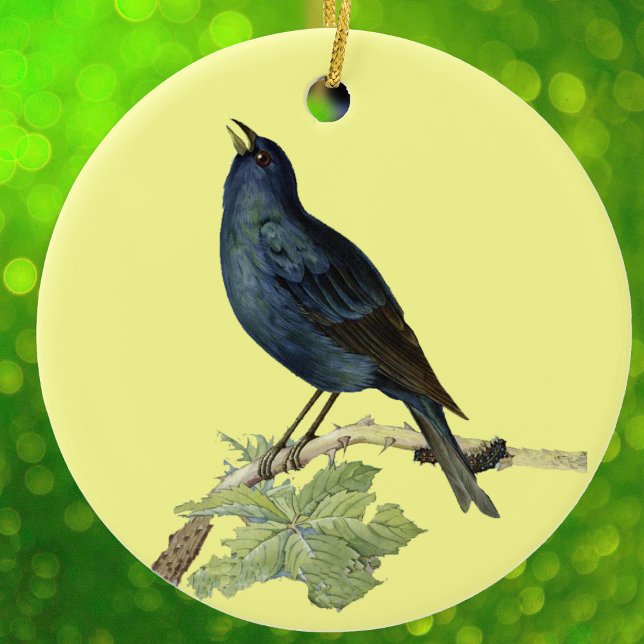 Ornamento De Cerâmica Pássaro Negro Elegante amarelo-pintado (Elegant singing black bird on branch with caterpillar leaves on yellow hanging ornament.)