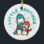 Ornamento De Cerâmica Pinguim Winter Little Brother<br><div class="desc">Dois pinguins bonitos em cachecóis e chapéus de inverno,  o pequeno comendo um cone de sorvete,  flocos de neve por toda parte,  com neve derramada de texto 'Little Brother'. Tem design de irmão mais velho e designs irmãs.</div>