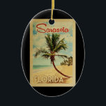 Ornamento De Cerâmica Sarasota Palm Tree Vintage Travel<br><div class="desc">A uniquely retro mid-century modern Sarasota Florida art print in vintage travel poster style. It features a curved palm tree on sandy beach with ocean under a blue cloudy sky.</div>