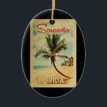 Ornamento De Cerâmica Sarasota Palm Tree Vintage Travel<br><div class="desc">A uniquely retro mid-century modern Sarasota Florida art print in vintage travel poster style. It features a curved palm tree on sandy beach with ocean under a blue cloudy sky.</div>