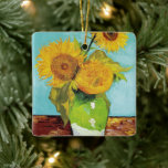 Ornamento De Cerâmica Três girassóis | Vincent van Gogh<br><div class="desc">Três Girassóis (1888), de Vincent van Gogh, é uma vida estática vibrante que apresenta os batimentos grossos da assinatura do artista e o uso ousado da cor. A pintura apresenta três girassóis em um vaso simples, suas pétalas ouros contrastando com o fundo azul aqua. A vívida paleta amarela de Van...</div>