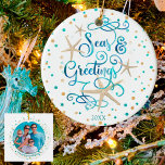 Ornamento De Cerâmica Tropical SEAsons Greetings Beach Script Photo<br><div class="desc">A fun twist on the traditional "Season's Greetings" with the words SEAS & GREETINGS featuring a tropical, coastal or beach look and feel to your Christmas holiday decor or beach house. The modern, elegant script typography is in a relaxing turquoise blue ocean watercolor accented by starfish and surrounded by turquoise...</div>