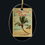 Ornamento De Cerâmica Viagens vintage de Palm Beach<br><div class="desc">Uma impressão de arte moderna de West Palm Beach,  na Flórida,  do século médio,  em estilo viagens vintage. Ele apresenta uma palmeira curva na praia arenosa com oceano sob um céu azul nublado.</div>