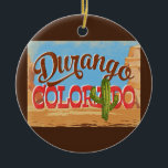Ornamento De Cerâmica Viagens vintage do Deserto de Cartoon do Durango C<br><div class="desc">Durango Colorado,  neo viagens vintage,  em engraçadinho,  estilo retrô apresentando o deserto,  um cacto e rochas. Azul,  marrom e vermelho com cacto verde.</div>