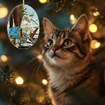 Ornamento De Cerâmica Viking Cat and Blue Dragon<br><div class="desc">Norwegian Forest cat sitting by a tree with a blue dragon sit-in a a bottle helmet. Snow all around them,  sword and viking axe with them.</div>