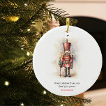 Ornamento De Cerâmica Vintage Nutcracker e Feliz Natal<br><div class="desc">Um soldado Nutcracker do estilo vintage, maravilhosamente ilustrado, resplandecente em seu traje clássico, fica alto, segurando uma bandeira Feliz de Natal. As cores ricas e quentes e os detalhes intrincados evocam uma sensação de nostalgia de yuletide, fazer-a uma escolha perfeita para aqueles que apreciam a estética de férias clássica. Que...</div>