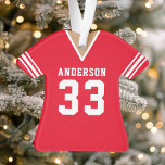 Ornamento Red Personated Futebol Jersey<br><div class="desc">Capturar o espírito do jogo com este adorno de camisa vermelha. Perfeito para qualquer fã de futebol, este ornamento exclusivo apresenta o seu nome e número personalizados num design de camisa clássico. Feito de materiais duráveis, é uma maneira festiva de mostrar seu espírito de equipe e adicionar um toque pessoal...</div>