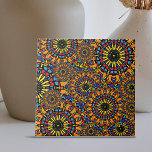 Padrão Ético Oriental Colorido do Floral, Mandalas<br><div class="desc">Este azulejo cerâmico apresenta detalhes complexos, semelhantes aos da mandala, fornecendo uma impressão caleidoscópica. O azulejo apresenta dois grandes padrões: um que se parece com um sol deslumbrante e outro composto por camadas complicadas de figuras geométricas dispostas em configurações circulares. Amarelo, vermelho, azul e preto dominam a paleta de cores,...</div>
