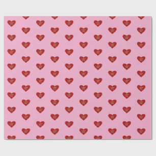 Papel de embrulho coração vermelho em fundo rosa a