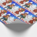 Papel De Presente Feliz Christma do inverno dos miúdos do vaqueiro e<br><div class="desc">O vaqueiro e a vaqueira caçoam em uma cena do inverno. O vaqueiro tem um laço com luzes de Natal. O texto diz o Feliz Natal. Há uma outra versão deste design que não diz o Feliz Natal.</div>