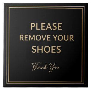 Placa de remover sapatos preta e dourada