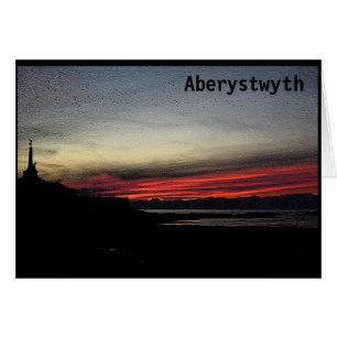Por do sol sobre o mar no cartão de Aberystwyth