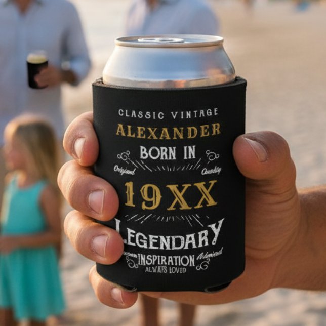 Porta-lata Aniversário Personalizado Adicionar Seu Nome Legen (Black and gold can cooler in a hand with a beach background.)