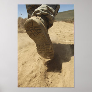 Poster A US soldier walks along a dirt path