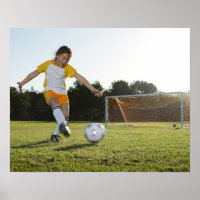 A young girl playing soccer on a soccer field in