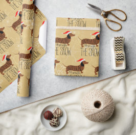Presente Dachshund através do papel de ondulação de neve