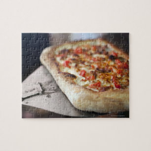 Quebra-cabeça A pizza com tomates, o alho e a carne substituem