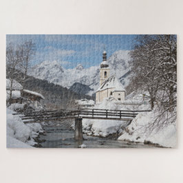 Quebra-cabeça Church in the snow with Alps mountains in winter