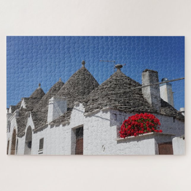 Quebra-cabeça Flores de gerânio e casas de trulli em Alberobello (Horizontal)