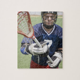 Quebra-cabeça Jogador sério do lacrosse que guardara o crosse