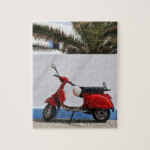 Quebra-cabeça Patinete de motor vermelho pela parede, ilha de