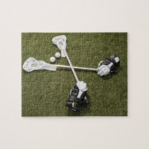 Quebra-cabeça Varas, luvas e bolas do Lacrosse em artificial