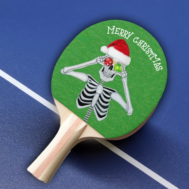Raquete De Ping Pong Feliz Natal Esqueleto Olhos Verdes (Merry Christmas skeleton ornament eyes Santa hat on green with gold flecks ping pong paddle.)