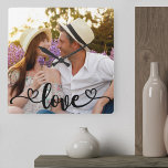 Relógio Quadrado Caligrafia por Foto de casal e Corações<br><div class="desc">Crie seu próprio relógio de fotos exclusivo. O modelo de foto está configurado pronto para você adicionar sua própria foto, que preencherá automaticamente o rosto inteiro do relógio. A camada de texto escrita à mão simplesmente lê "amor" em bela caligrafia com corações amorosos em cada extremidade. Você pode personalizar esta...</div>