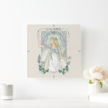Relógio Quadrado Galadriel Light of Valinor Graphic<br><div class="desc">Step into the radiant grace of Middle-Earth™ with this exquisite Lord of the Rings™ design inspired by Galadriel™. Illustrated in an elegant, Art Nouveau–inspired style, she stands poised and luminous, holding a phial of the Light of Valinor with serene strength and quiet authority. Flowing golden hair, delicate Elven adornments, and...</div>