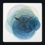 Relógio Quadrado Planetas em Evolução - Círculos de Aquarela<br><div class="desc">Planetas Evolutivos I por Grace Popp. Círculos de aquarela criam formas como planetas que se sobrepõem para revelar belas variações de azul e lacre.</div>