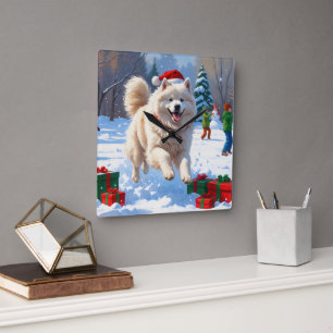 Relógio Quadrado Samoyed Correndo na Neve com Chapéu de Natal