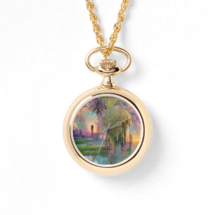 Relógio Willow e wisteria pela lagoa no pôr do sol