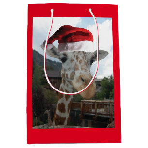 Sacola Para Presentes Média Girafa vestindo um chapéu de Papai Noel no Natal