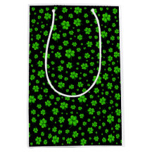 Pattern of green shamrocks on black background