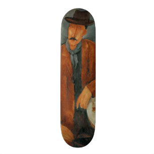 Skate Um homem assentado que inclina-se em uma mesa