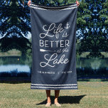 Toalha De Praia Personalized Life Is Better At The Lake<br><div class="desc">Upgrade your outdoor setup at your lakeside abode with this cute personalized beach towel featuring the phrase "life is better at the lake" in white lettering accented with an anchor and an oar. Personalize with your family name and/or year established beneath. Perfect for lake house housewarming parties, summer homes, or...</div>