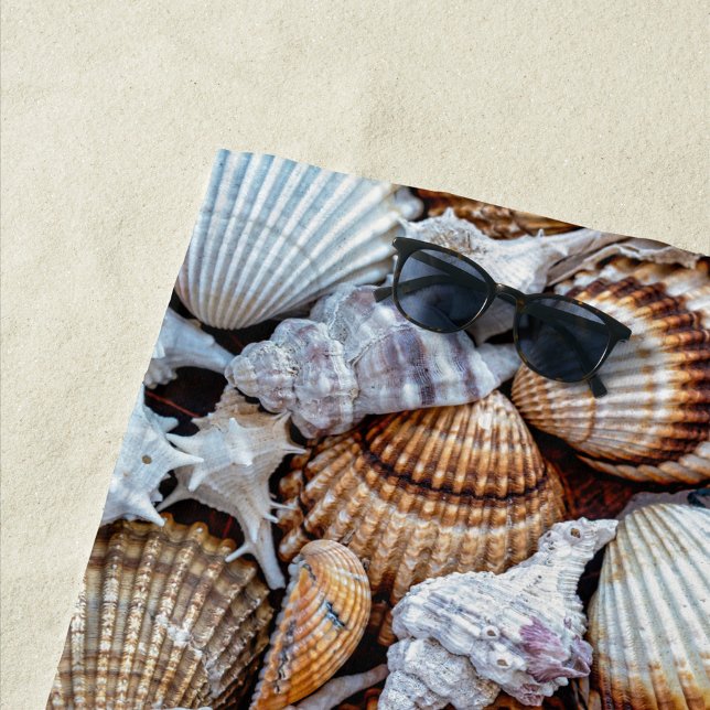 Toalha De Praia Sea Shells Beach Towel (A vibrant collection of seashells scattered across a sandy surface. )