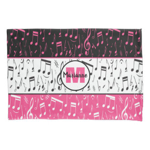 travesseiro de notas de música preto-e-rosa e bra