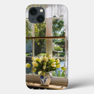 Window with lace curtain and tulips